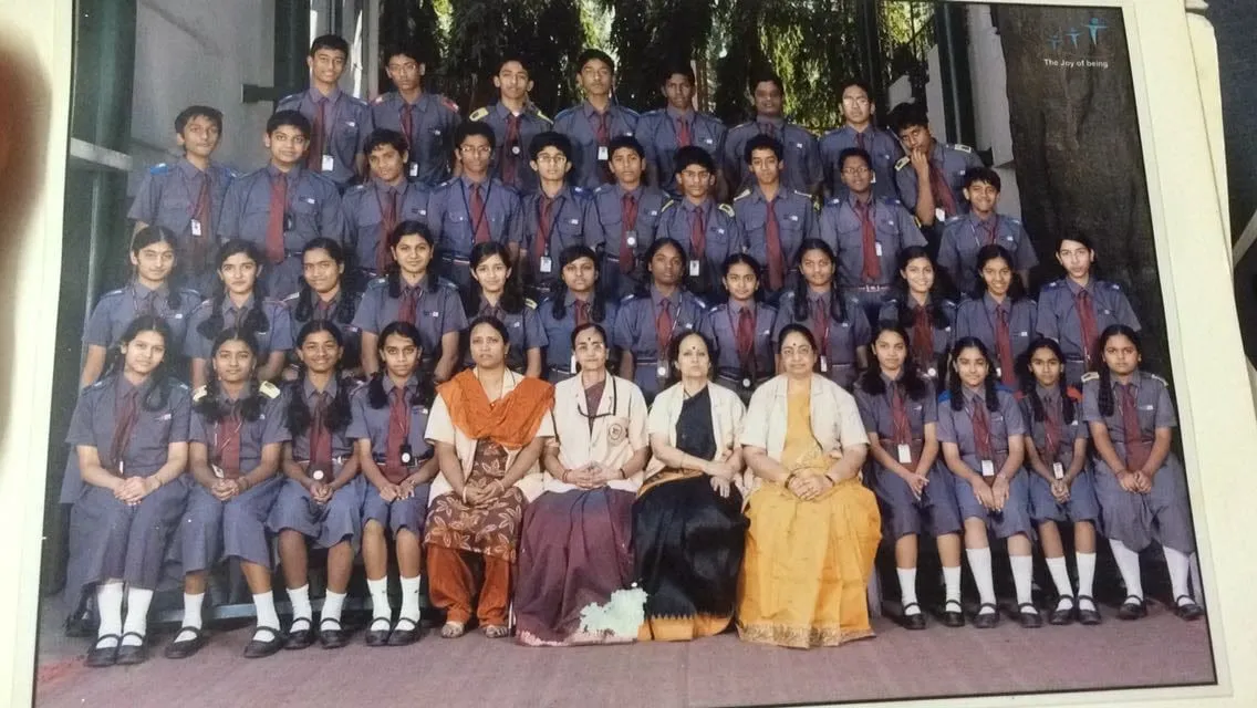 A school class photograph — rows of uniformed students with their teachers.