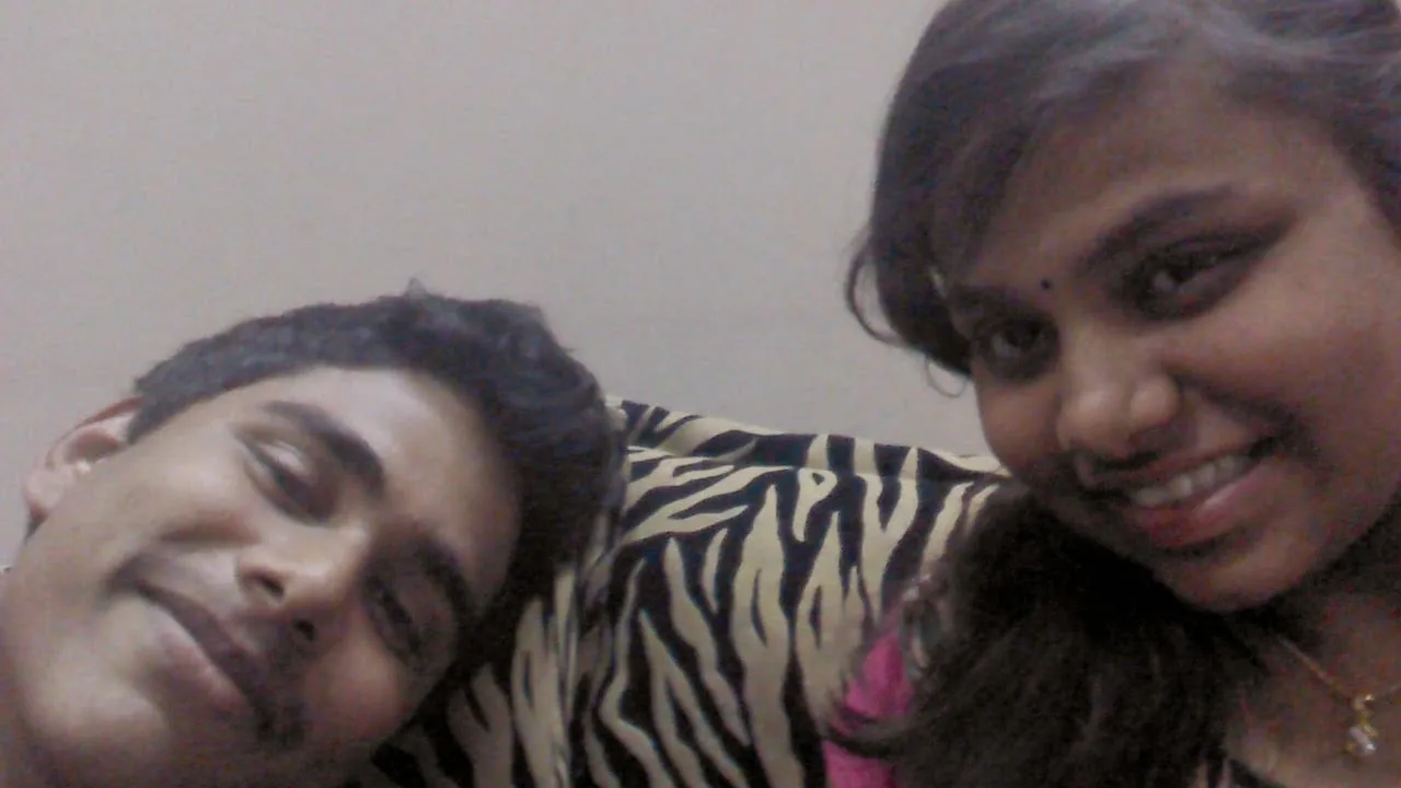 A close, candid selfie of two friends indoors.