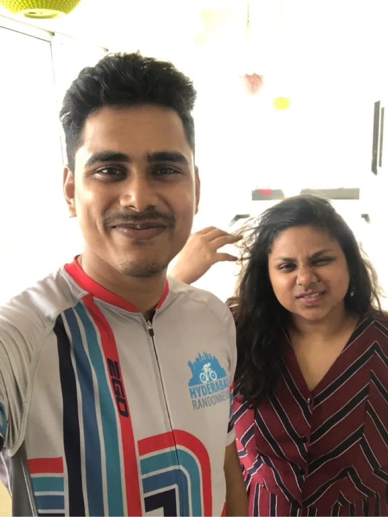 Two friends pulling playful faces for a selfie.