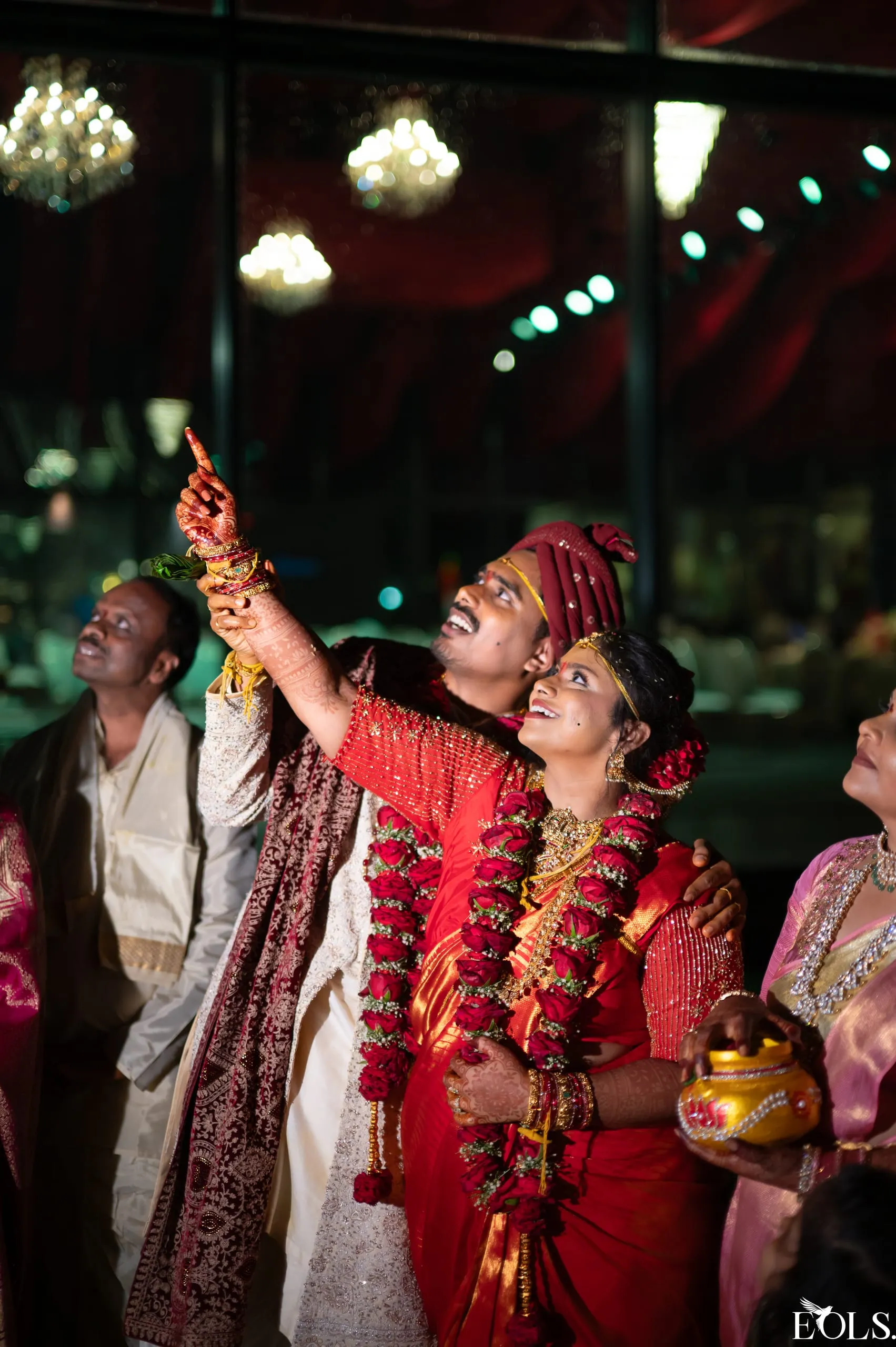 Swathi laughing during an evening wedding ceremony, warm light