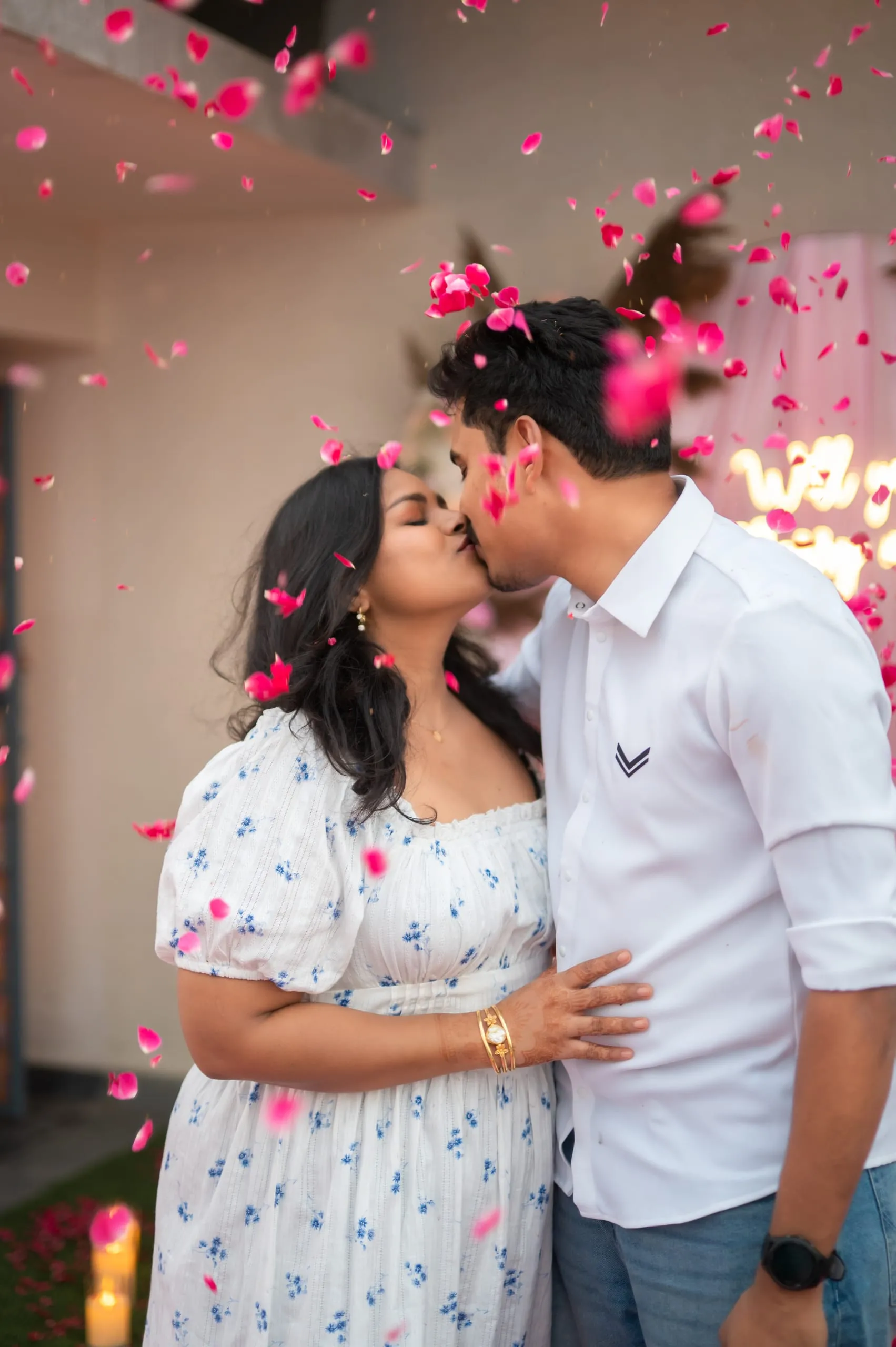 She said yes — sealed with a kiss and a shower of petals.